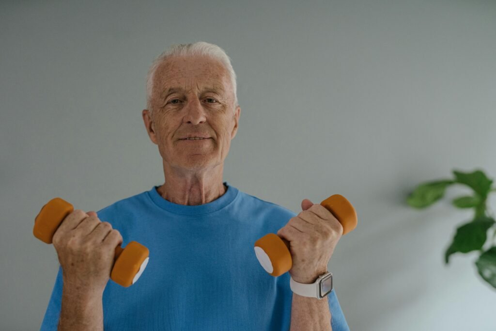 An Elderly Man in Blue Shirt Holding Dumbbells